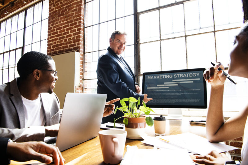 Group of diverse businesspeople in a meeting executive explaining the importance of digital marketing for business