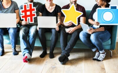 social media advertising - people holding symbols related to social media