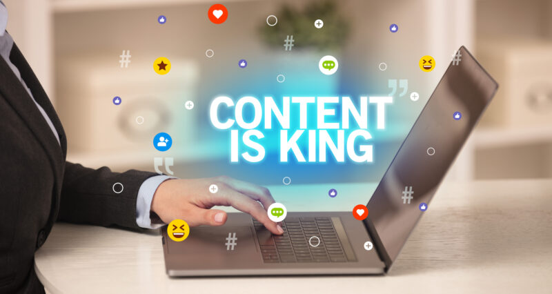 Freelance woman using laptop women using laptop and the image states content is king - showing the importance of content creation